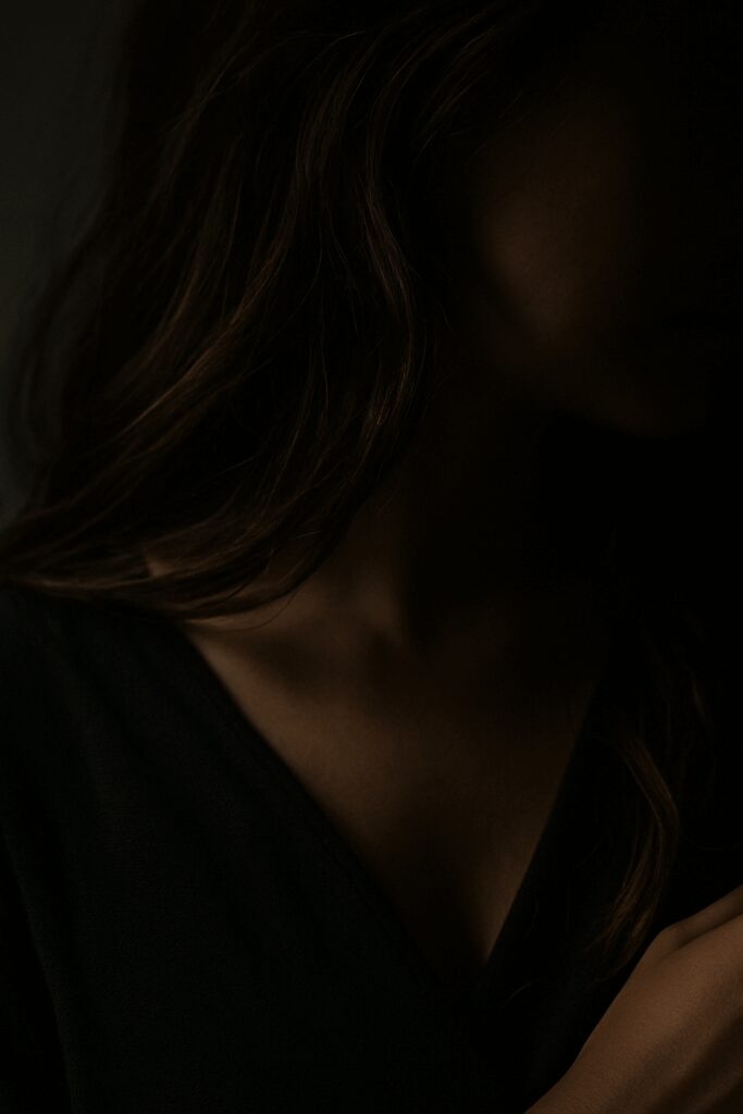 Silhouette of a woman in low light.