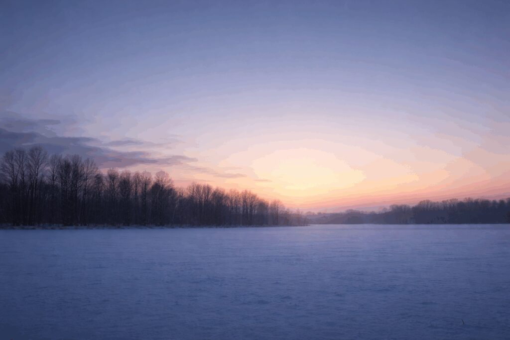 Winter sunrise over a snowy landscape.