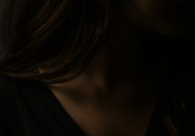 Silhouette of a woman in low light.