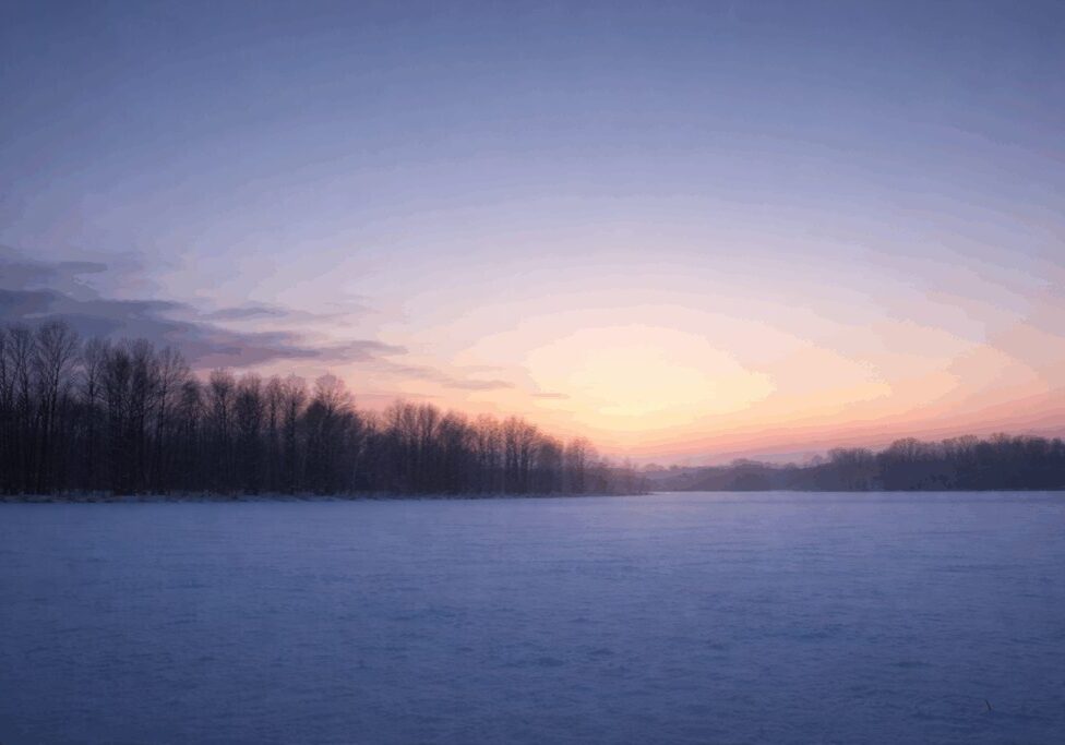 Winter sunrise over a snowy landscape.